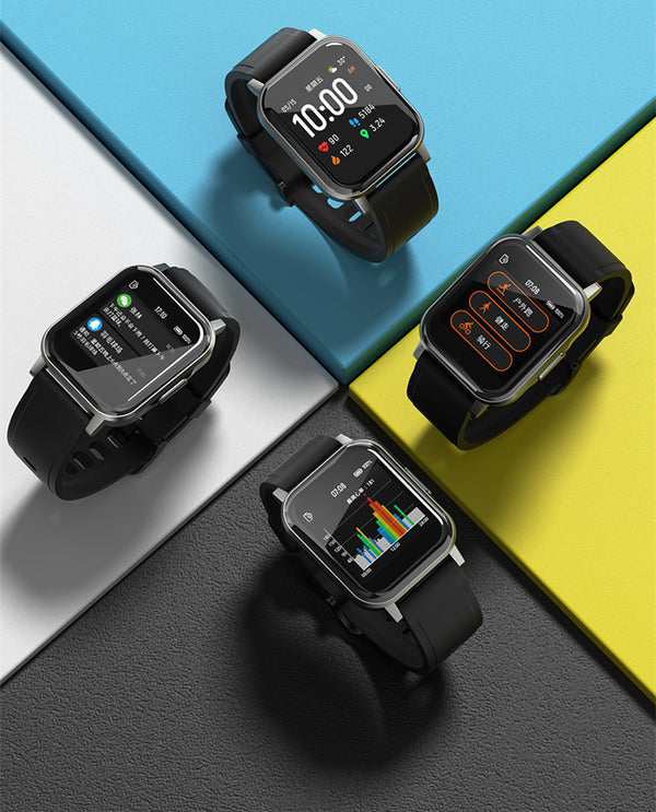 Four black smartwatches on a colorful geometric background